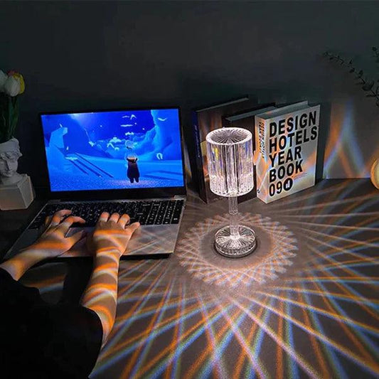 16 colors diamond lamp casting colorful light patterns on a desk near a laptop and books