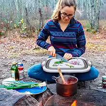 Woman using 2 in 1 Cutting board and foldable wash basin from Clarify.pk while preparing food outdoors