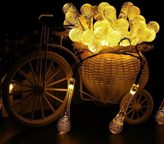 20 bulb decorative fairy lights for home glowing warm yellow in a wicker basket on a decorative bike