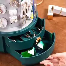Clarify.pk 360 rotating jewelry organizer with multiple drawers holding earrings and rings