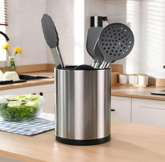 Clarify.pk 360 rotating kitchen utensil holder in stainless steel with black kitchen tools on a wooden countertop