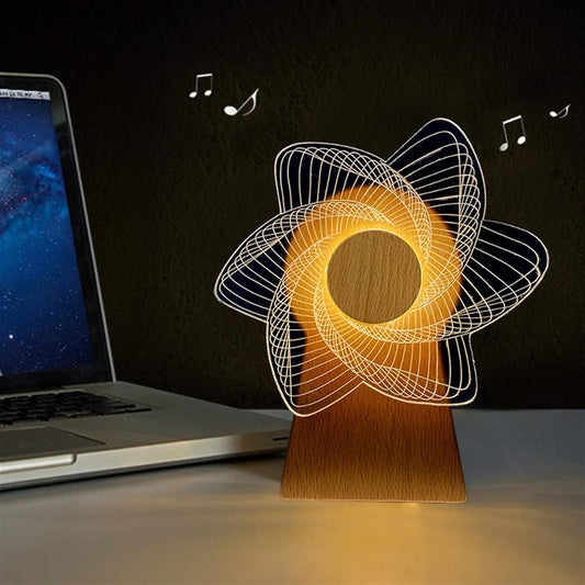 3D windmill night light lamp with wooden base glowing next to a laptop on a desk