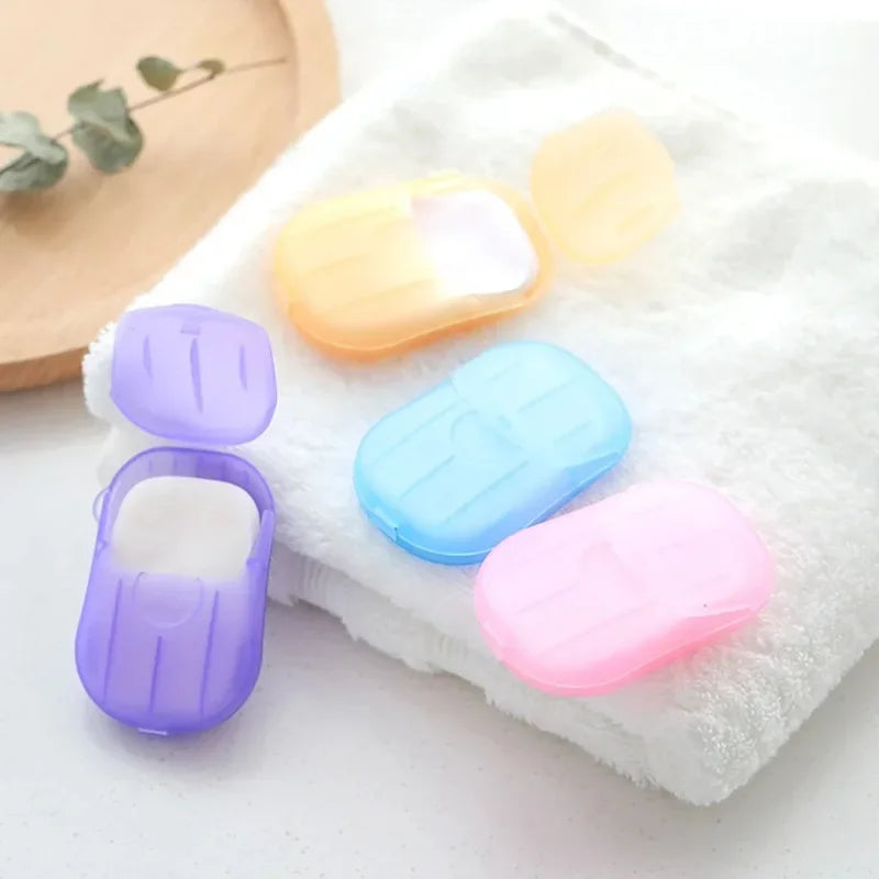 4 box travel soap paper sheets in colorful portable cases with white soap sheets on towel