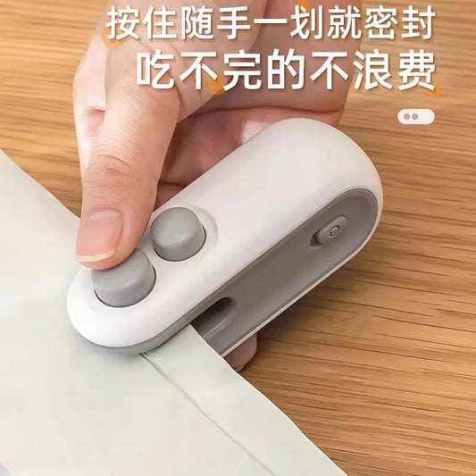 Automatic charging and sealing machine Small hand-pressed household sealing device Mini portable snack plastic bag