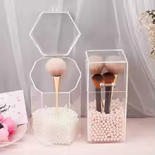 Clear acrylic cosmetic organizer boxes holding makeup brushes with white pearl beads inside