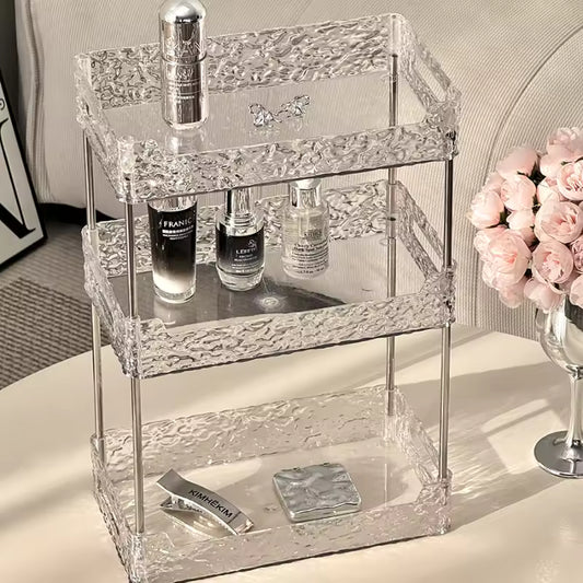 Clarify.pk acrylic shower organizer with three textured clear shelves holding skincare bottles and cosmetics