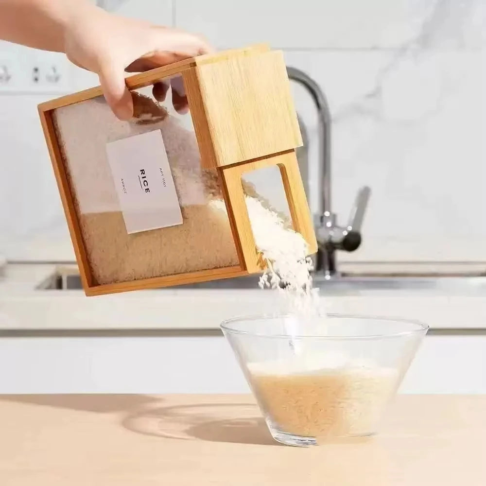 Hand pouring rice from bamboo grain storage box with flip spout into glass bowl on kitchen counter
