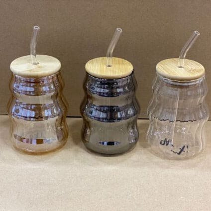 Set of three bamboo lid glass mug with straw in different colors for eco-friendly drinkware use