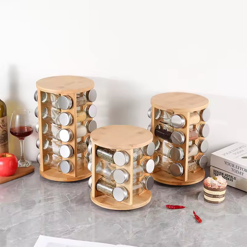 Clarify.pk bamboo spice rack organizer set with rotating glass jars and silver lids on kitchen countertop