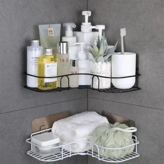 Black and white bathroom corner shelf wall mounted with toiletries, towels, and bath accessories in gray tiled corner