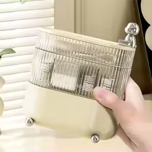 Clarify.pk 360 degree jewelry organizer with clear compartments and beige base held in hand