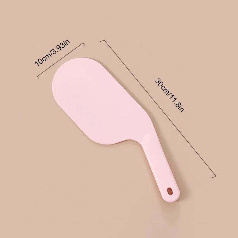 Pink plastic bed sheet tucker tool measuring 30cm by 10cm with handle hole for easy grip