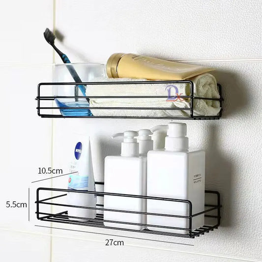 Black bathroom shelf organizer mounted on wall holding toiletries and towel in bathroom