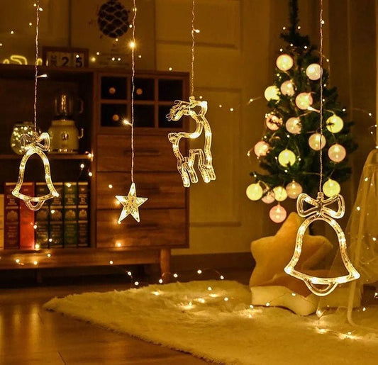 Christmas star fairy lights featuring illuminated bells, star, and reindeer decorations hanging in a cozy living room