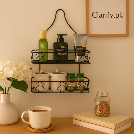 Black double layer bathroom rack from Clarify.pk mounted on beige wall holding toiletries and containers