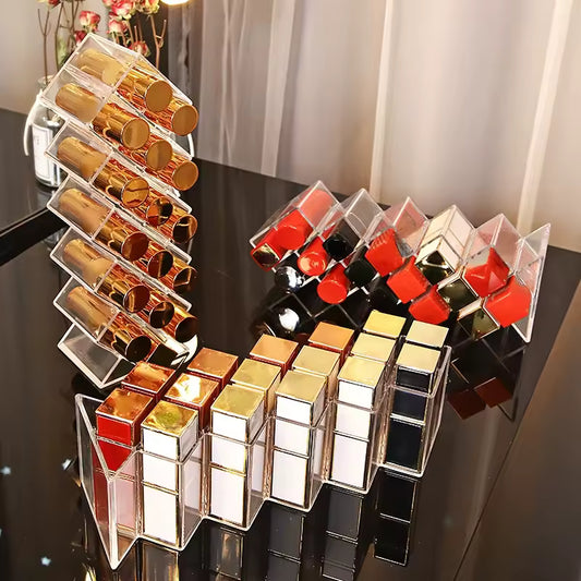 Clear lipstick organizer with compartments holding various lipsticks on a black surface