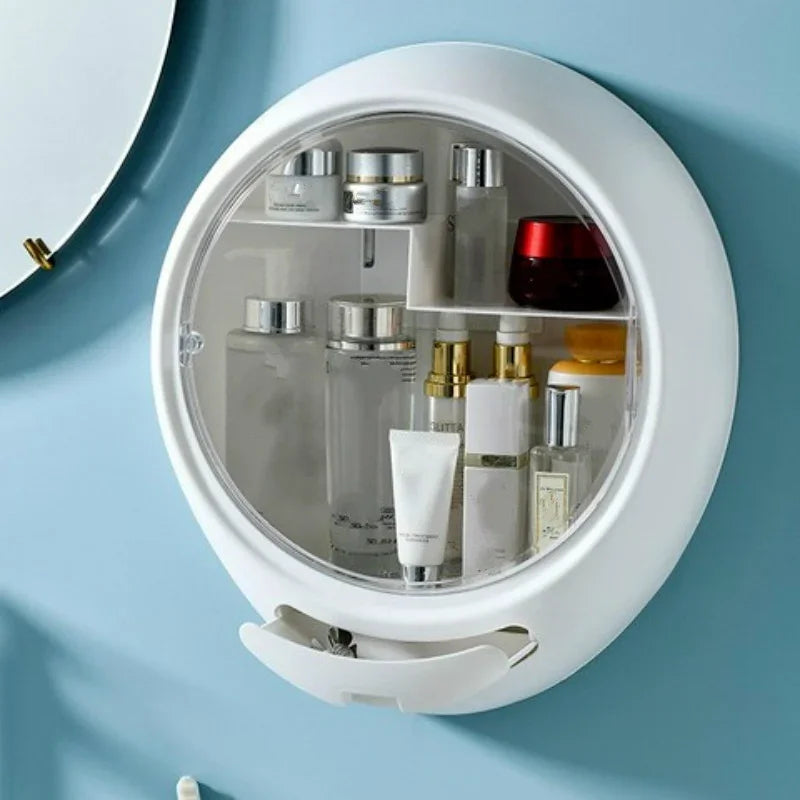 White wall-mounted round cosmetic storage box with transparent door holding skincare bottles and jars