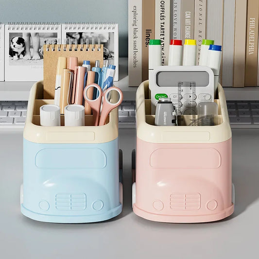 Creative desktop pen holder in blue and pink shaped like mini vans filled with pens, markers, and office supplies