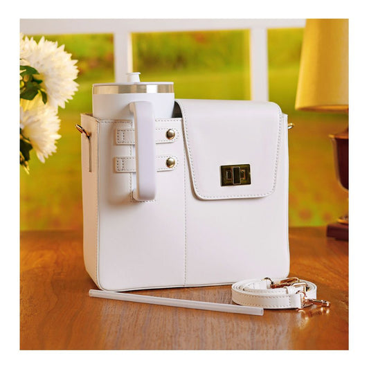 White crossbody water bottle carrier bag with secure flap and detachable strap on wooden table