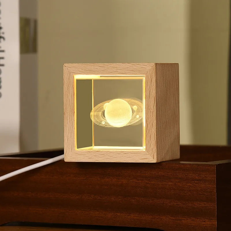 Crystal bedside lamp for bedroom with wooden frame and 3D planet design glowing on nightstand
