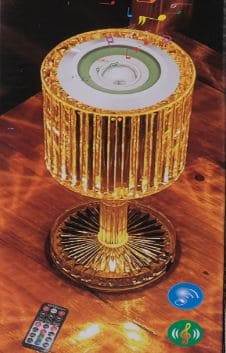 Golden crystal lamp with bluetooth speaker and remote control on wooden table by Clarify.pk