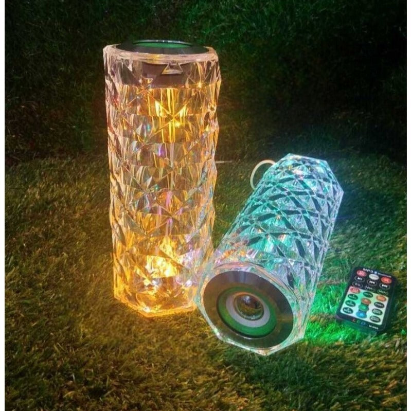 Crystal lamp with bluetooth speaker set featuring intricate geometric design and remote control on grass