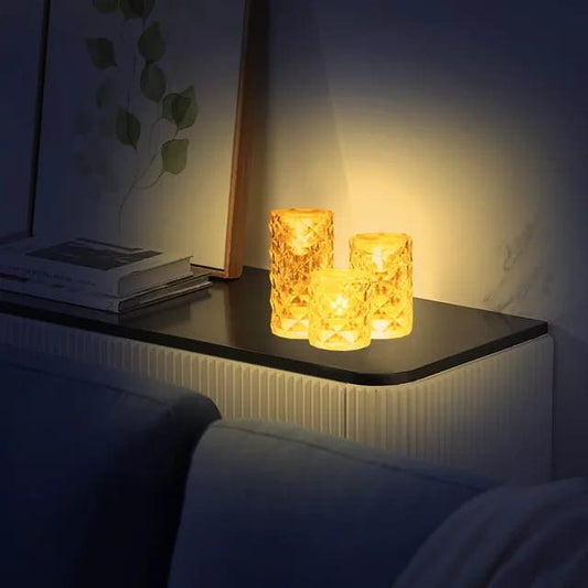 Warm glowing crystal rose Crystal lamp trio on black side table in cozy living room