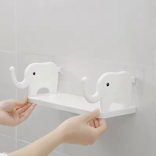 White cute animal design wall organizer with elephant shapes holding a small shelf on a tiled wall