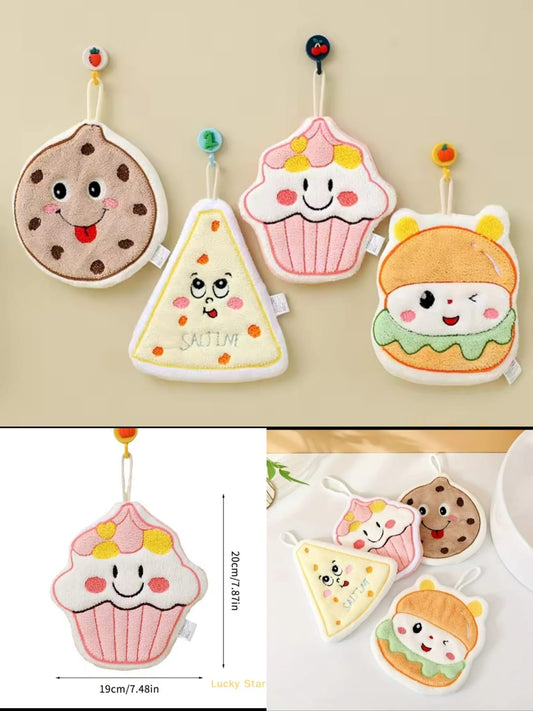 Cute cartoon hand towels featuring smiling cookie, pizza, cupcake, and burger designs hanging on hooks