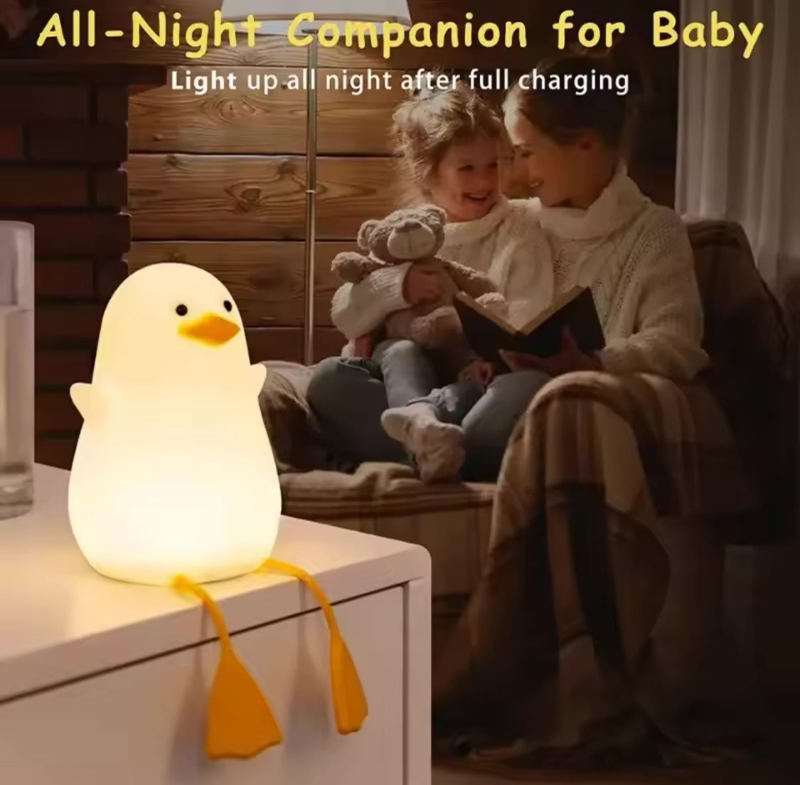 Cute duck night lamp glowing softly on table next to mother reading to baby in cozy room