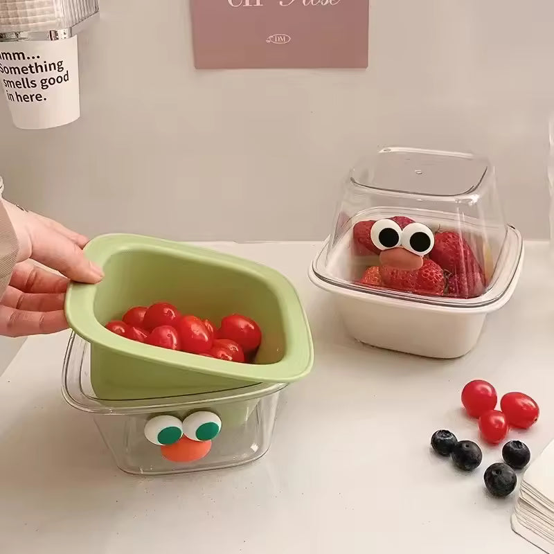 Cute fruit drain basket with green strainer and clear container featuring playful eyes for kitchen use