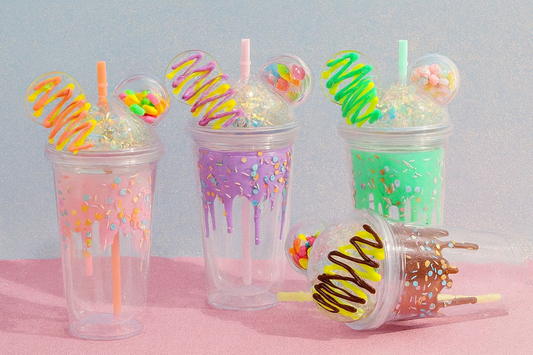 Cute water sipper for kids with colorful drips and candy decorations in pink purple and green