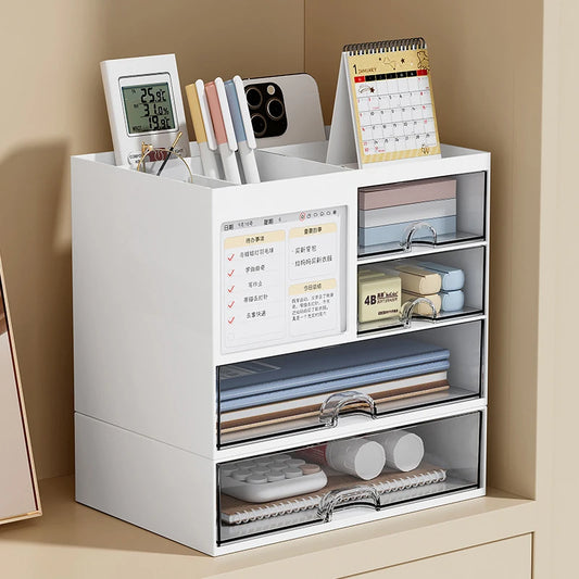White desktop drawer storage box with compartments holding pens, calendar, remote, and notebooks