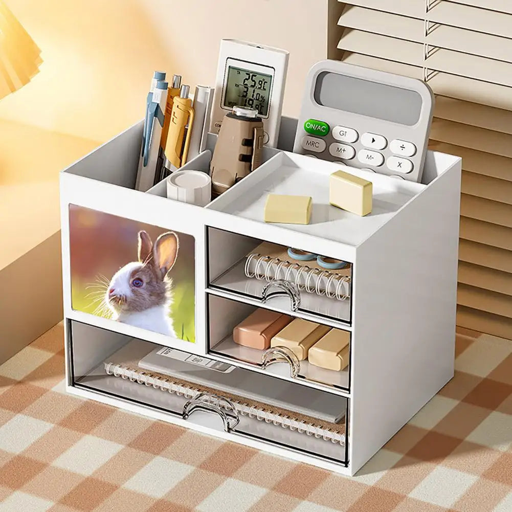 Clarify.pk white desktop organizer with drawers holding pens, sticky notes, calculator, and notebooks