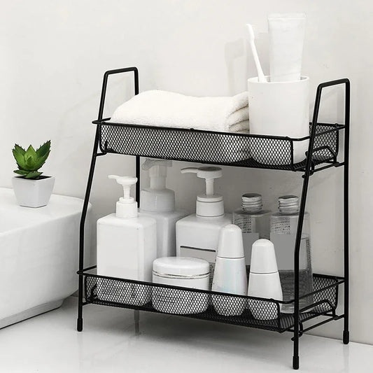 Black metal double layer kitchen storage rack holding various bottles and a towel in a modern bathroom