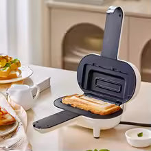 Clarify.pk double sided sandwich press open with toasted sandwich inside on kitchen counter