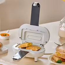 Clarify.pk white double sided sandwich press with toasted sandwiches inside on kitchen countertop