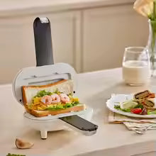 Double sided sandwich press from Clarify.pk heating a shrimp sandwich on a kitchen counter