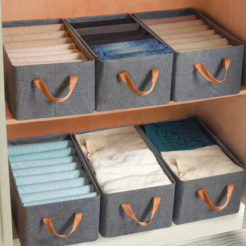 Gray fabric drawer organizer for closet with leather handles neatly storing folded clothes and accessories