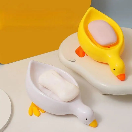 Duck-shaped soap dish in yellow and white holding soap bars from Clarify.pk