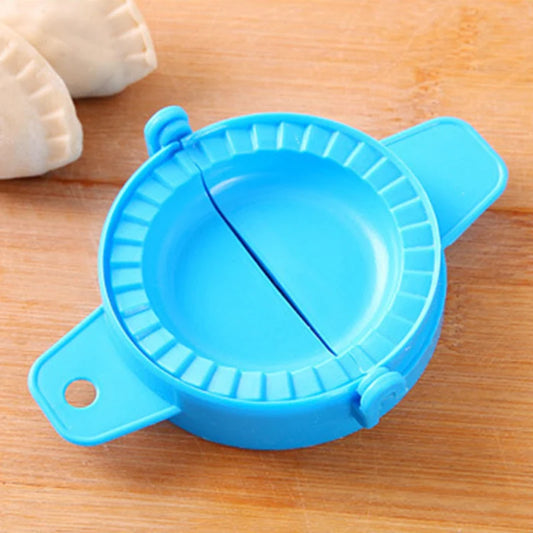 Blue dumpling mold kitchen tool on wooden surface with folded dumplings nearby
