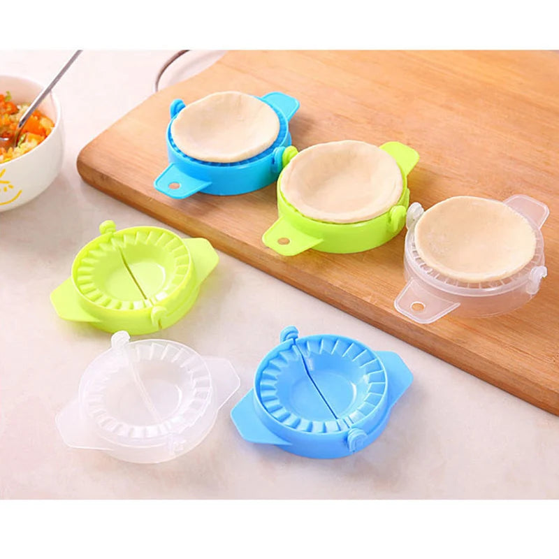 Colorful dumpling mold kitchen tool set with dough and filling on wooden cutting board