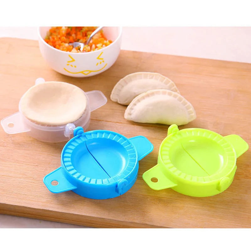 Blue and green dumpling mold kitchen tool set on wooden board with dough and filling bowl