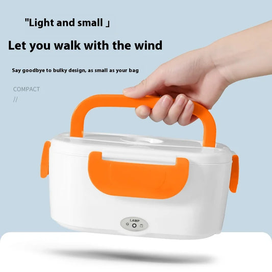 Compact electric heated lunch box with orange handle and latches held in hand for portable use