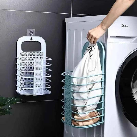 Clarify.pk foldable laundry basket hanging next to washing machine with clothes inside
