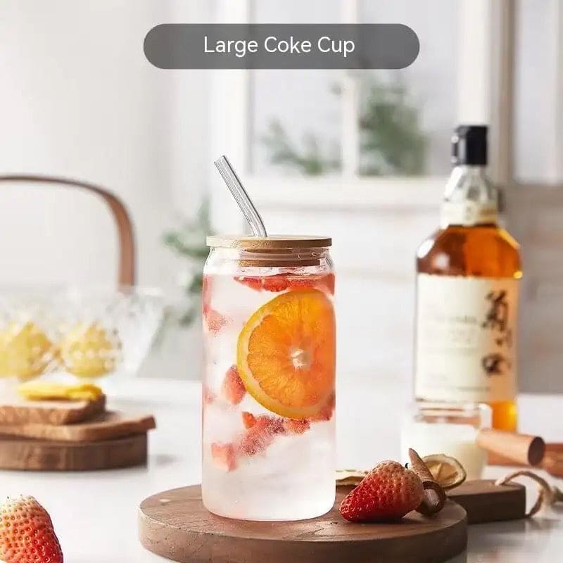 Clarify.pk bamboo lid iced coffee mug with glass straw filled with iced citrus and strawberries on wooden coaster