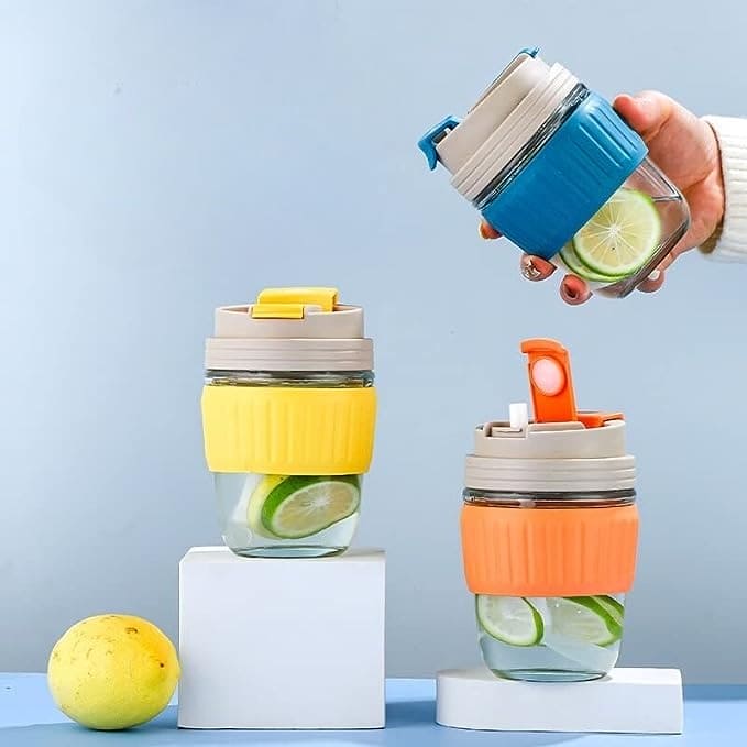 Clarify.pk 350ml cute travel mug set with colorful silicone grips and lids shown with lime slices and water