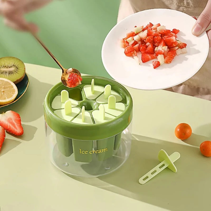 Green ice cream maker with multiple molds for homemade frozen treats and fresh fruit toppings