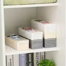 White and gray stackable storage boxes arranged in a shelf organizer wardrobe from Clarify.pk