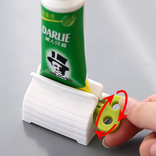 Toothpaste tube squeezer in white and green used to efficiently squeeze toothpaste from a green Darlie tube
